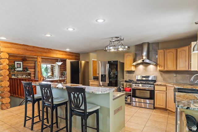 986 E 2290 N, Monroe, UT 84754 - kitchen featuring wall chimney exhaust hood, stainless steel appliances, log walls, a center island with sink, and decorative backsplash