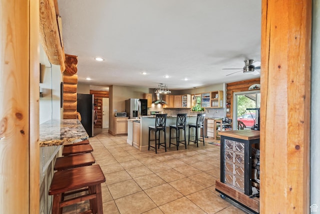 986 E 2290 N, Monroe, UT 84754 - kitchen with stainless steel fridge with ice dispenser, freestanding refrigerator, light tile patterned floors, a breakfast bar area, and recessed lighting