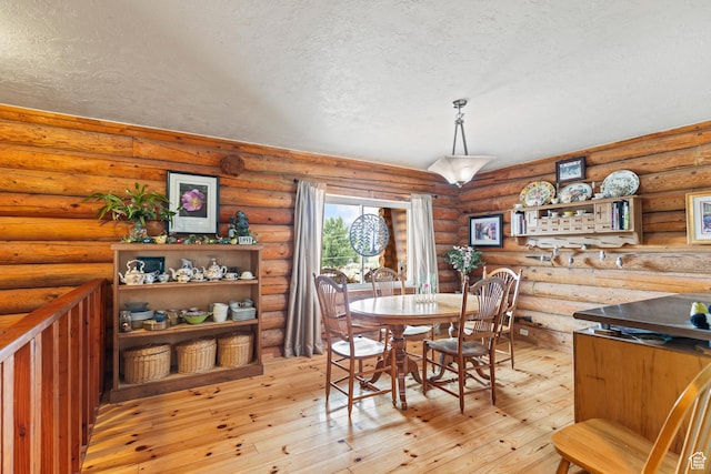 986 E 2290 N, Monroe, UT 84754 - dining space featuring a textured ceiling, light wood-style flooring, and log walls
