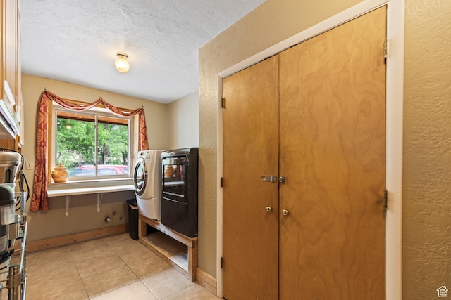 986 E 2290 N, Monroe, UT 84754 - laundry area with a textured wall, a textured ceiling, light tile patterned floors, cabinet space, and washing machine and clothes dryer