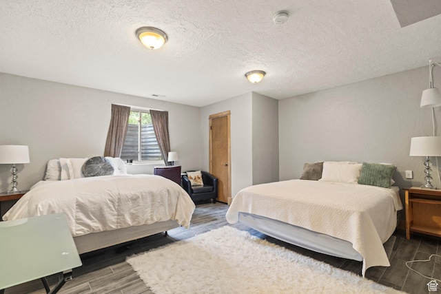 986 E 2290 N, Monroe, UT 84754 - bedroom featuring wood finished floors and a textured ceiling