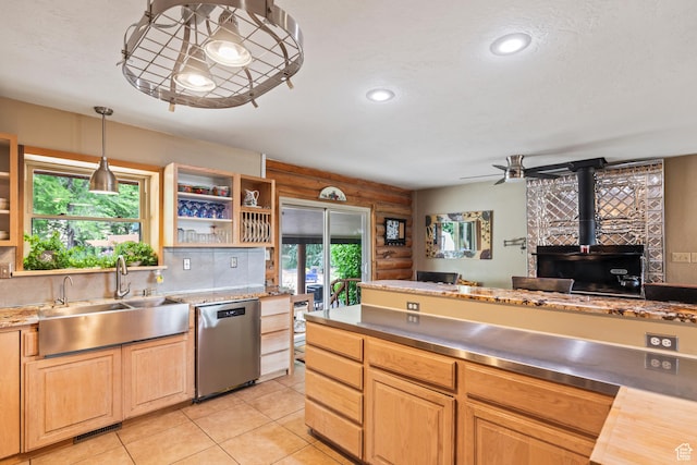 986 E 2290 N, Monroe, UT 84754 - kitchen featuring dishwasher, a wood stove, light tile patterned flooring, light brown cabinets, and decorative light fixtures