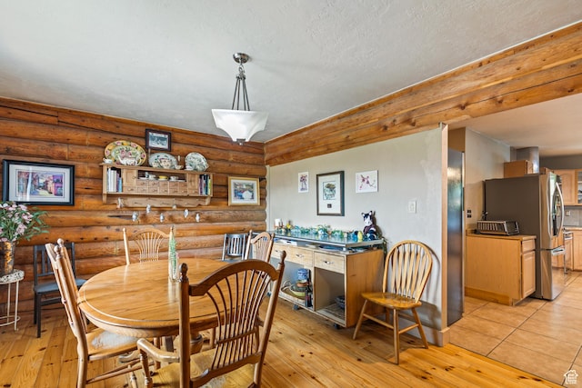 986 E 2290 N, Monroe, UT 84754 - dining area featuring rustic walls, light wood finished floors, and a textured ceiling