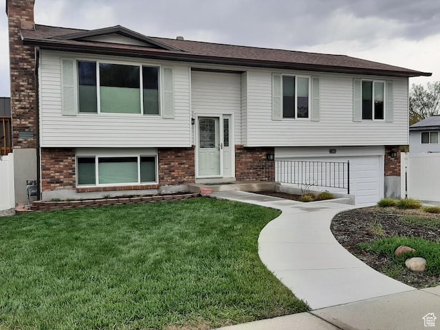 2165 W Tierra Rose Dr, Taylorsville, UT 84129 - raised ranch featuring brick siding, a front lawn, and a chimney