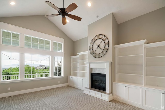 5843 W Wildflower Ln, Highland, UT 84003 - unfurnished living room featuring a ceiling fan, a glass covered fireplace, plenty of natural light, light carpet, and high vaulted ceiling