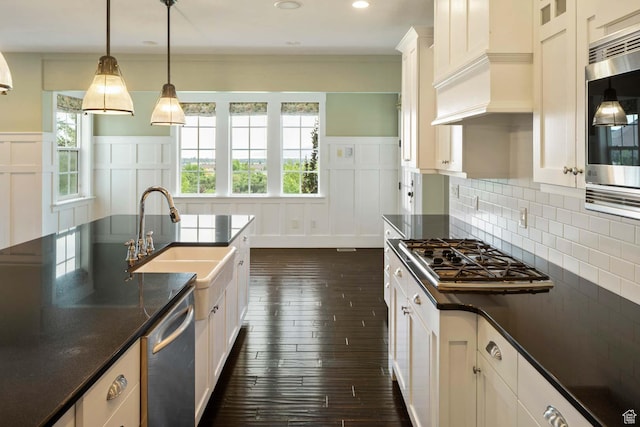 5843 W Wildflower Ln, Highland, UT 84003 - kitchen featuring appliances with stainless steel finishes, dark wood finished floors, a decorative wall, a wainscoted wall, and white cabinetry