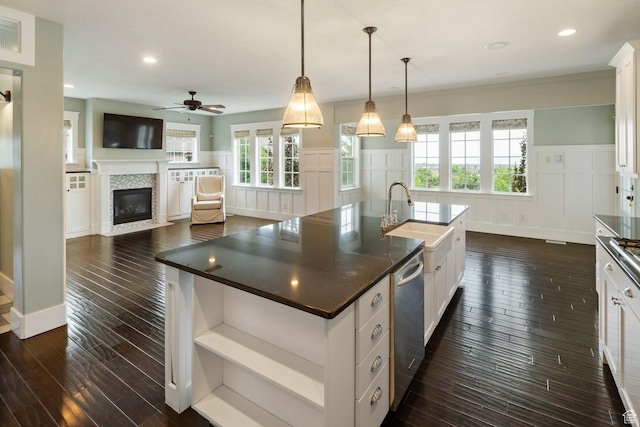 5843 W Wildflower Ln, Highland, UT 84003 - kitchen with a decorative wall, dark wood finished floors, dark countertops, dishwasher, and a fireplace with flush hearth
