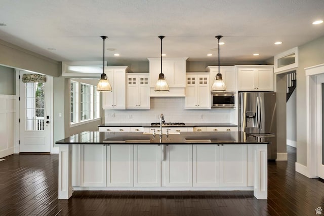5843 W Wildflower Ln, Highland, UT 84003 - kitchen with appliances with stainless steel finishes, dark countertops, dark wood-style flooring, white cabinets, and recessed lighting