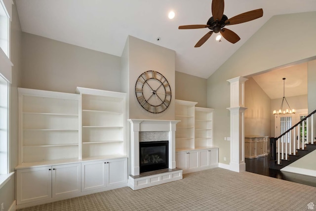 5843 W Wildflower Ln, Highland, UT 84003 - unfurnished living room with a ceiling fan, a glass covered fireplace, high vaulted ceiling, carpet floors, and a chandelier