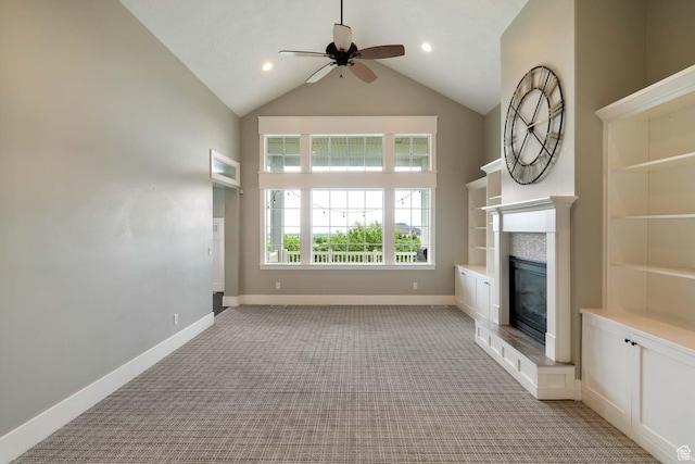 5843 W Wildflower Ln, Highland, UT 84003 - unfurnished living room with light carpet, a ceiling fan, high vaulted ceiling, and a glass covered fireplace