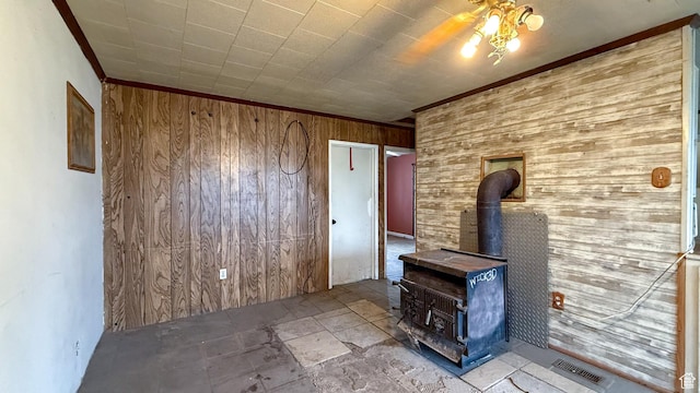 127 Grassy Dr, East Carbon, UT 84520 - unfurnished living room featuring wooden walls, a wood stove, and crown molding