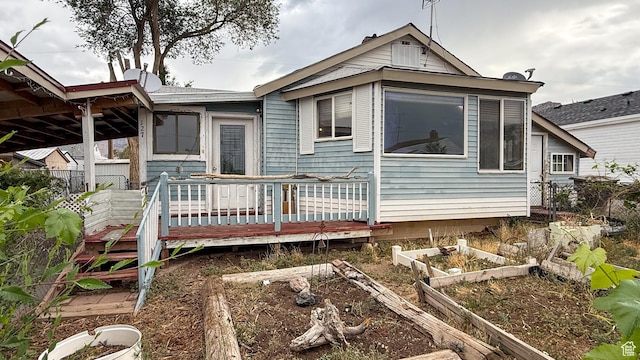 127 Grassy Dr, East Carbon, UT 84520 - rear view of house featuring a garden and a deck