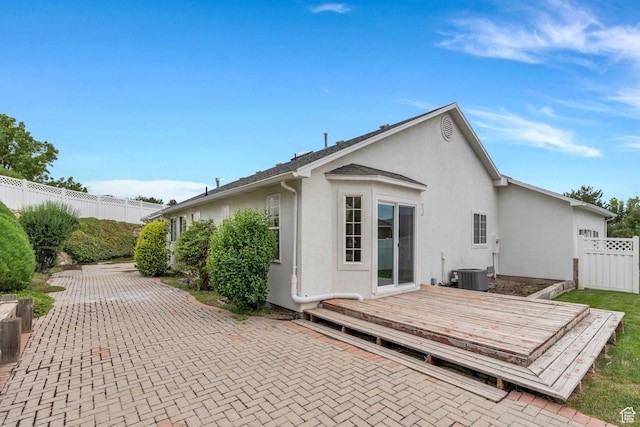 12060 S Lampton Dr W, Riverton, UT 84065 - back of property with stucco siding, a fenced backyard, a deck, and a patio area