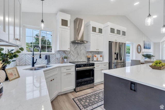 12060 S Lampton Dr W, Riverton, UT 84065 - kitchen with stainless steel fridge, electric range oven, wall chimney exhaust hood, lofted ceiling, and white cabinets