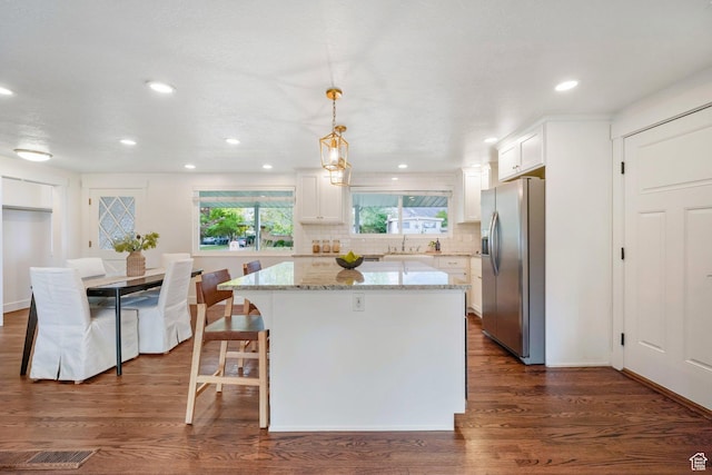 1767 N 1400 W, Provo, UT 84604 - kitchen featuring stainless steel fridge, white cabinets, light stone countertops, a kitchen island, and tasteful backsplash