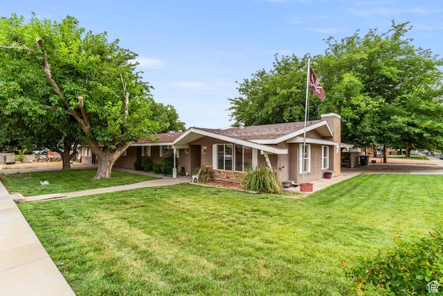 283 S 400 W, Hurricane, UT 84737 - view of front of home featuring a front lawn, stucco siding, and a chimney
