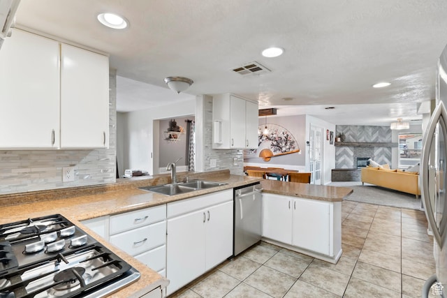 283 S 400 W, Hurricane, UT 84737 - kitchen with appliances with stainless steel finishes, light countertops, a peninsula, open floor plan, and white cabinetry