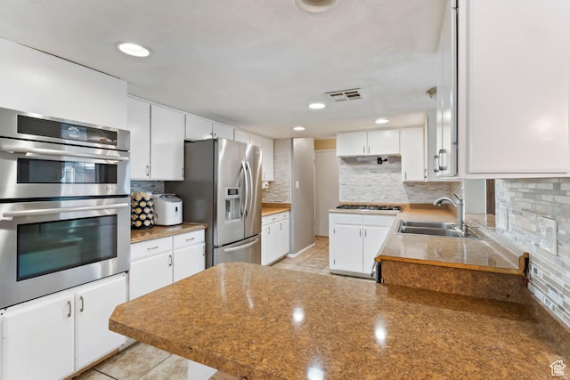 283 S 400 W, Hurricane, UT 84737 - kitchen featuring appliances with stainless steel finishes, tasteful backsplash, white cabinetry, a peninsula, and recessed lighting