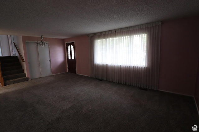547 E 6295 S, Murray, UT 84107 - unfurnished living room featuring a chandelier, carpet, a textured ceiling, and stairway
