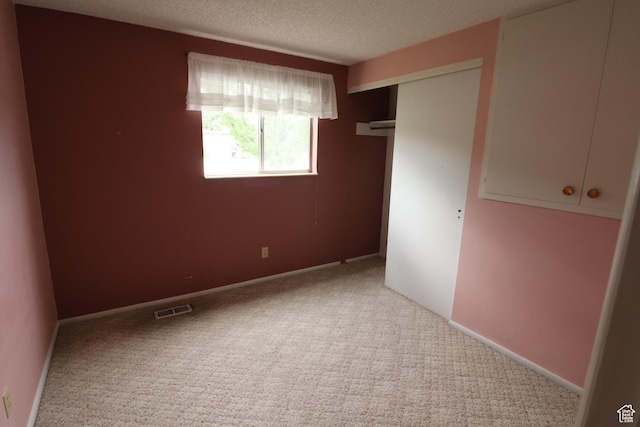 547 E 6295 S, Murray, UT 84107 - unfurnished bedroom featuring carpet floors, a closet, and a textured ceiling