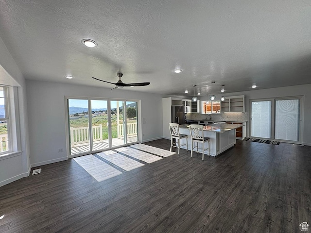 34840 N 10265 E, Fairview, UT 84629 - living area with dark wood finished floors, ceiling fan, healthy amount of natural light, a textured ceiling, and recessed lighting