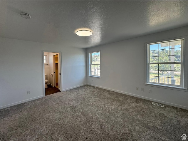34840 N 10265 E, Fairview, UT 84629 - unfurnished bedroom featuring dark colored carpet, a textured ceiling, and ensuite bathroom