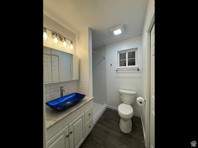 34840 N 10265 E, Fairview, UT 84629 - full bathroom featuring vanity, tasteful backsplash, a tile shower, and wood finished floors