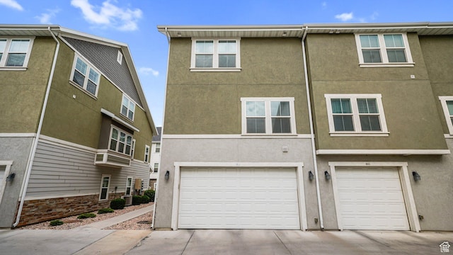 319 N 750 E, Vineyard, UT 84059 - rear view of house featuring stucco siding, concrete driveway, and a garage