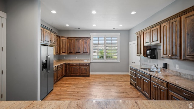 319 N 750 E, Vineyard, UT 84059 - kitchen with stainless steel refrigerator with ice dispenser, light wood finished floors, recessed lighting, light stone counters, and dark brown cabinetry