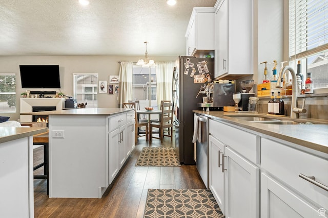 2319 N Penstemon Way, Lehi, UT 84043 - kitchen with dark wood-type flooring, a chandelier, white cabinetry, dishwasher, and a textured ceiling
