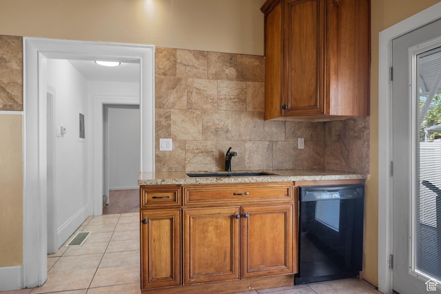 1145 Kensington Ave, Salt Lake City, UT 84105 - kitchen with dishwasher, brown cabinetry, decorative backsplash, and light tile patterned flooring