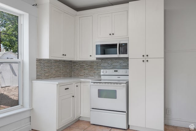 1145 Kensington Ave, Salt Lake City, UT 84105 - kitchen with white electric range oven, light countertops, backsplash, and white cabinets