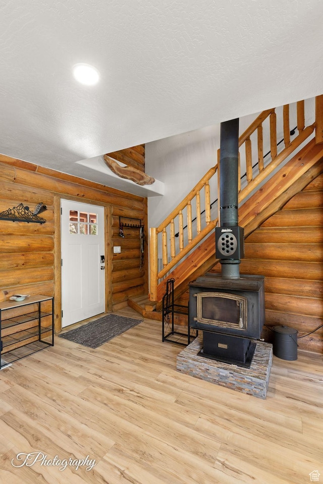 503 S Cottonwood Dr, Brookside, UT 84782 - entryway featuring log walls, stairs, wood finished floors, and a wood stove