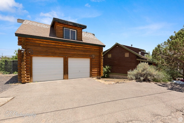 503 S Cottonwood Dr, Brookside, UT 84782 - view of side of home with log siding and asphalt driveway