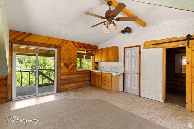 503 S Cottonwood Dr, Brookside, UT 84782 - kitchen with light countertops, ceiling fan, brown cabinets, and log walls