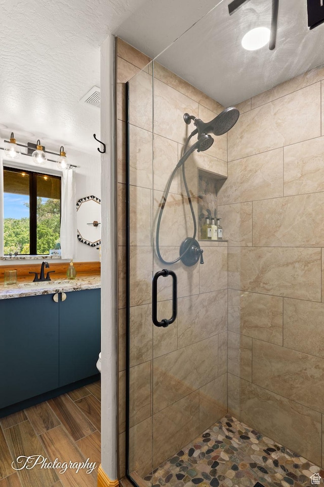 503 S Cottonwood Dr, Brookside, UT 84782 - bathroom featuring a shower stall, vanity, and wood finish floors