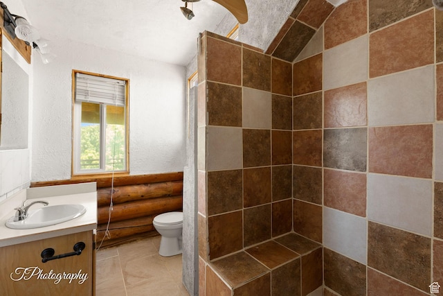 503 S Cottonwood Dr, Brookside, UT 84782 - full bathroom with vanity, tiled shower, and a textured wall