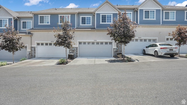 5681 W Pelican Ridge Ln, Salt Lake City, UT 84118 - multi unit property featuring driveway, a garage, and stone siding