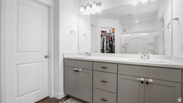 5681 W Pelican Ridge Ln, Salt Lake City, UT 84118 - full bath featuring a shower stall, double vanity, a walk in closet, and wood finished floors