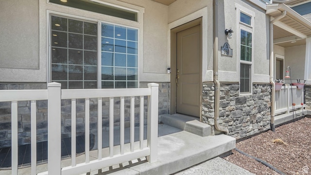 5681 W Pelican Ridge Ln, Salt Lake City, UT 84118 - doorway to property with stucco siding and stone siding