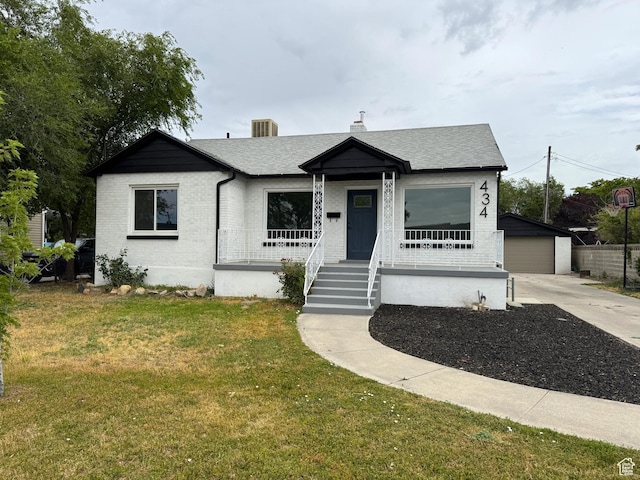 434 W Alta View Dr S, Midvale, UT 84047 - view of front facade with covered porch, a front yard, brick siding, an outbuilding, and roof with shingles