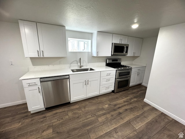 434 W Alta View Dr S, Midvale, UT 84047 - kitchen with appliances with stainless steel finishes, dark wood-style floors, white cabinetry, and a textured ceiling