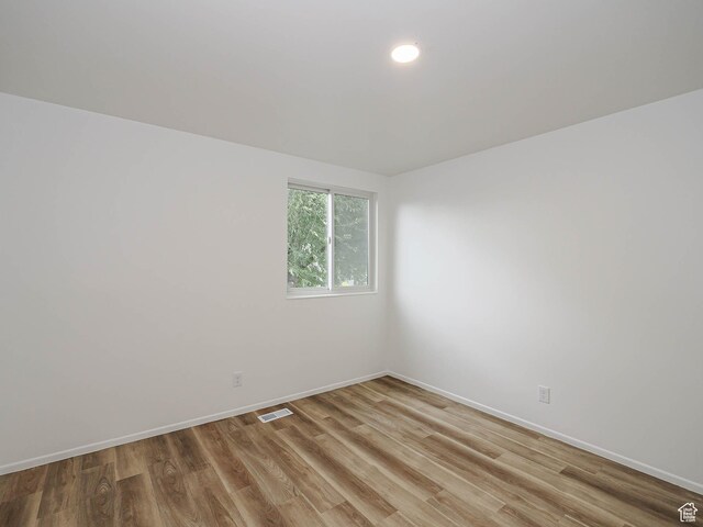 9971 S Borg Dr, Sandy, UT 84092 - spare room featuring light wood-type flooring and recessed lighting