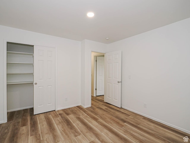 9971 S Borg Dr, Sandy, UT 84092 - unfurnished bedroom featuring wood finished floors, a closet, and recessed lighting