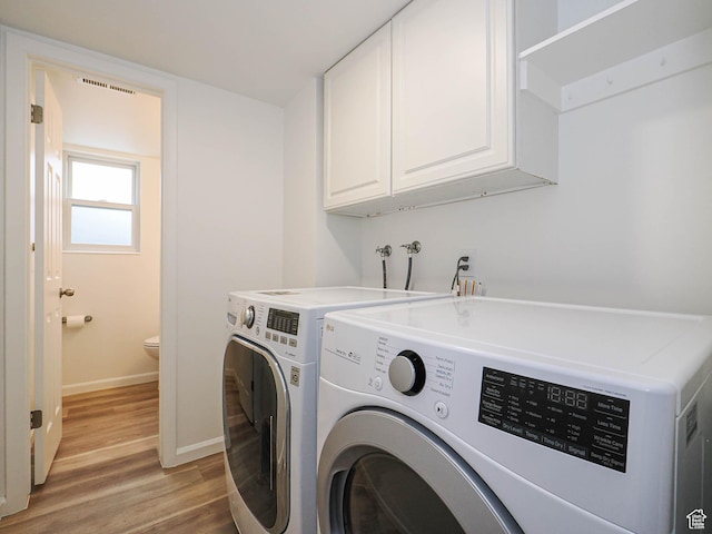 9971 S Borg Dr, Sandy, UT 84092 - washroom featuring cabinet space, washing machine and dryer, and light wood finished floors