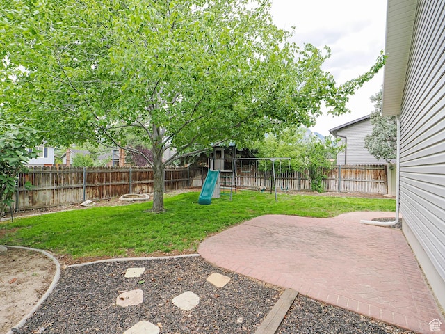9971 S Borg Dr, Sandy, UT 84092 - fenced backyard featuring a playground and a patio area