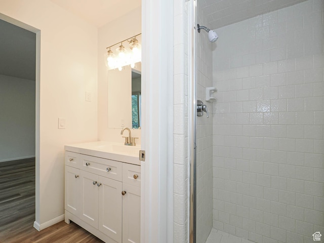 9971 S Borg Dr, Sandy, UT 84092 - bathroom featuring wood finished floors, a stall shower, and vanity