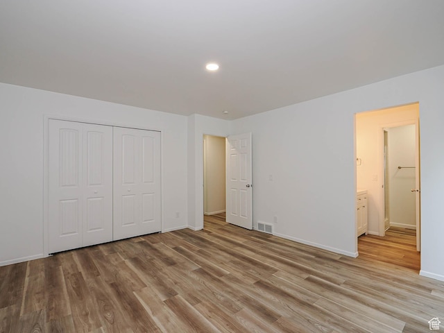 9971 S Borg Dr, Sandy, UT 84092 - unfurnished bedroom featuring light wood-style flooring, recessed lighting, and a closet
