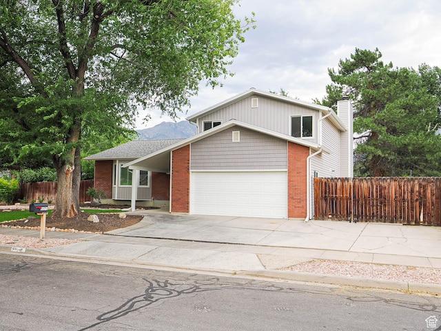 9971 S Borg Dr, Sandy, UT 84092 - traditional home with driveway, brick siding, and a garage