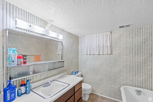 1602 S 550 W, Woods Cross, UT 84087 - bathroom with wallpapered walls, a freestanding tub, vanity, and a textured ceiling